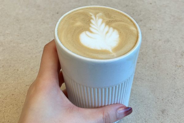 0094B969-7951-4D8E-B507-472896BC5EAA 2 A woman is grabbing a cup of coffee.